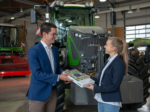 Fendt Mitarbeiterin und Mitarbeiter stehen vor einem Fendt Schlepper