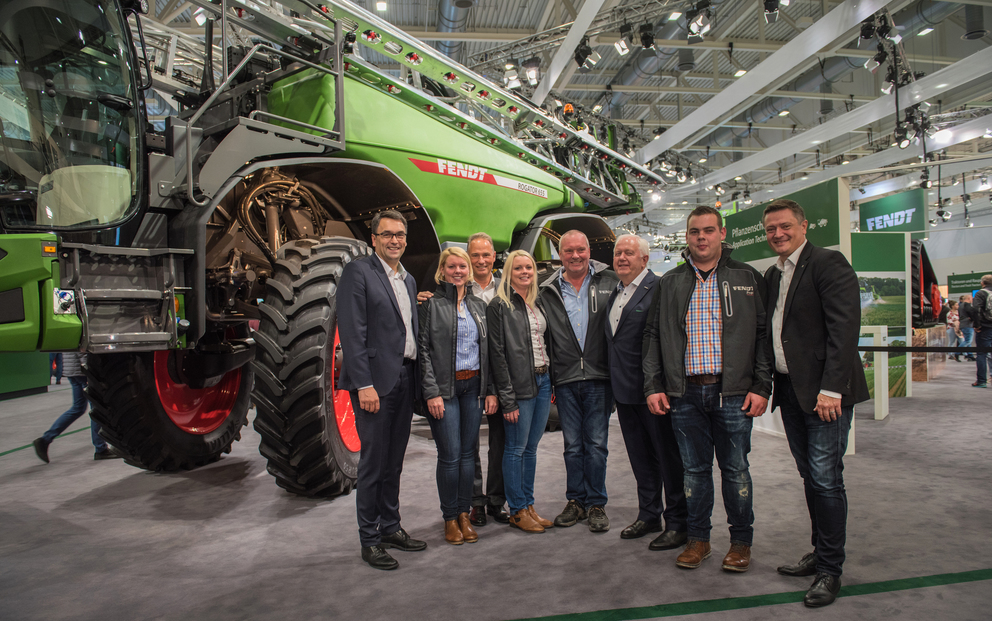 Seven people standing in front of the first Fendt Sprayer
