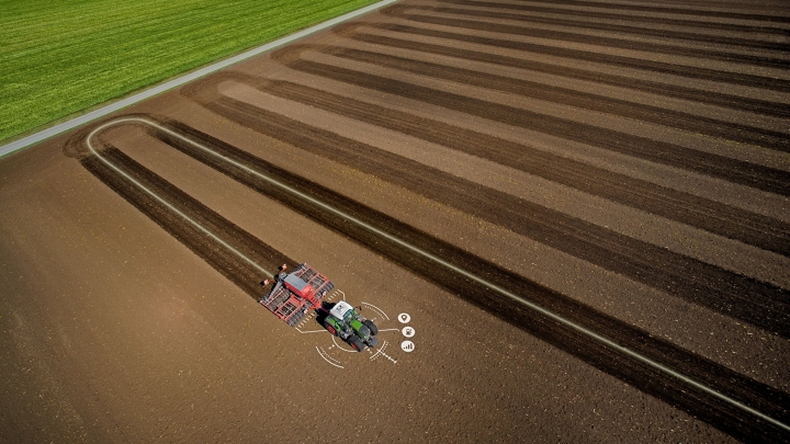A tractor driving across a field, with the precise track visible.