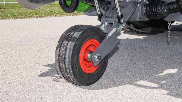 Close-up of a transport wheel folded out on a dirt path