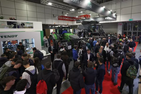 Viele Besucher stehen auf dem Fendt Stand mit einem Fendt Großtraktor und Fendt IDEAL Mähdrescher