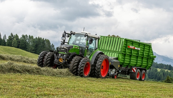 Ansicht eines Gespanns aus Fendt Traktor und Fendt Tigo Ladewagen im alpinen Grünfutter-Ernteeinsatz