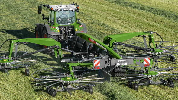 Fendt Schwader Ein grüner Fendt Traktor auf einem grünen Feld im Einsatz mit einem Schwader
