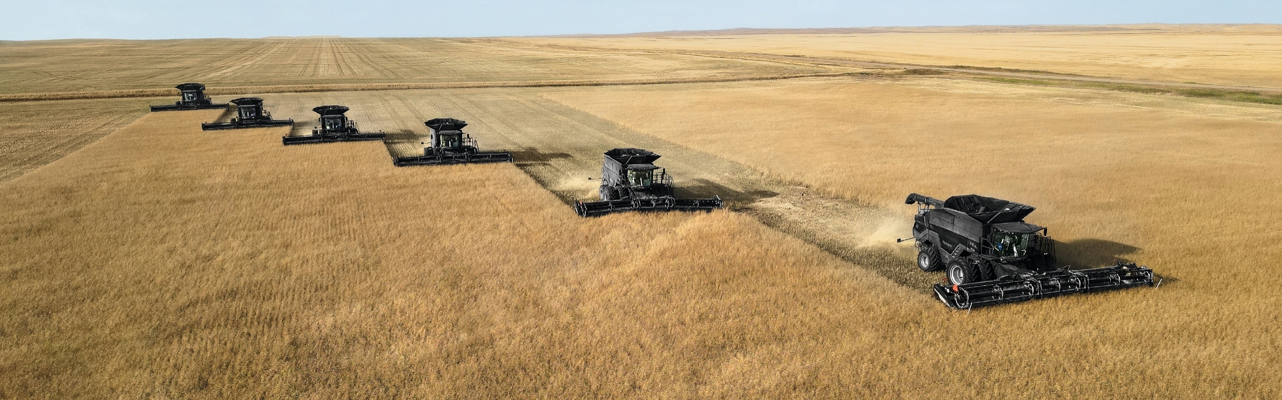 Fendt IDEAL 9T ved tærskning med mørke skyer på himlen