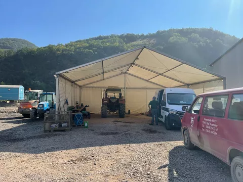 Mobile tractor workshop in a tent