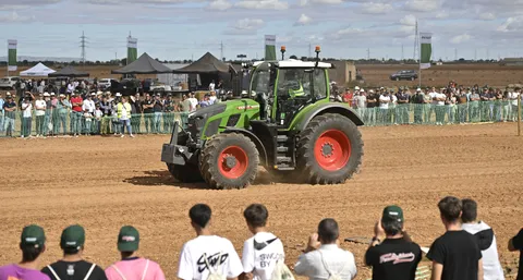 A Fendt600 Vario presented at Fendtgüinos 2024 audience in the front and back behind a green security fence