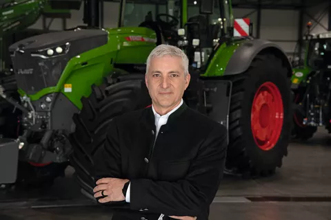 Eric Hansotia,Chairman,President and CEO AGCO in front of a Fendt tractor
