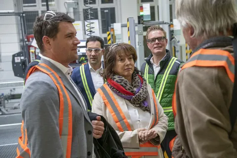 People at the transfer point Fendt high-bay warehouse