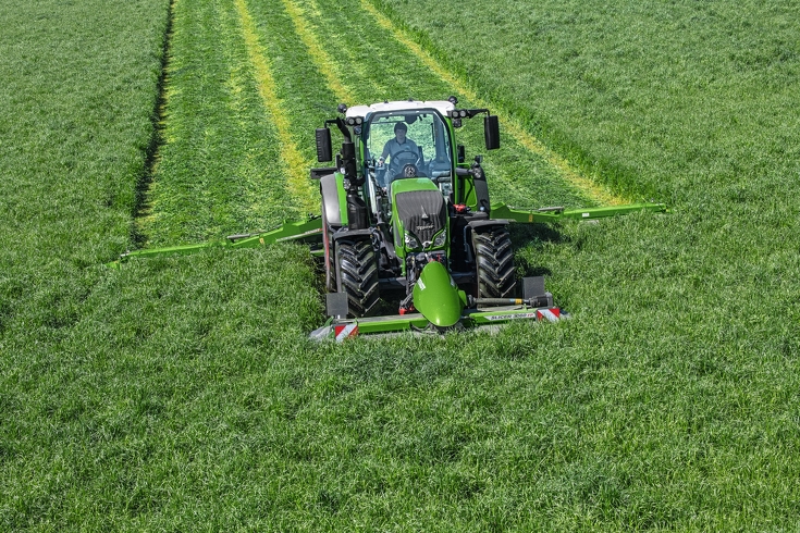 Fendt tractor with mowers mows grass Fendt tractor with mowers mows grass