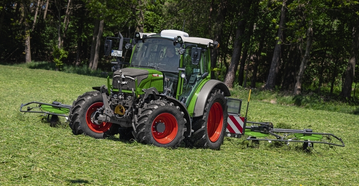 Fendt 211 Vario in grassland work with Fendt windrower attachment