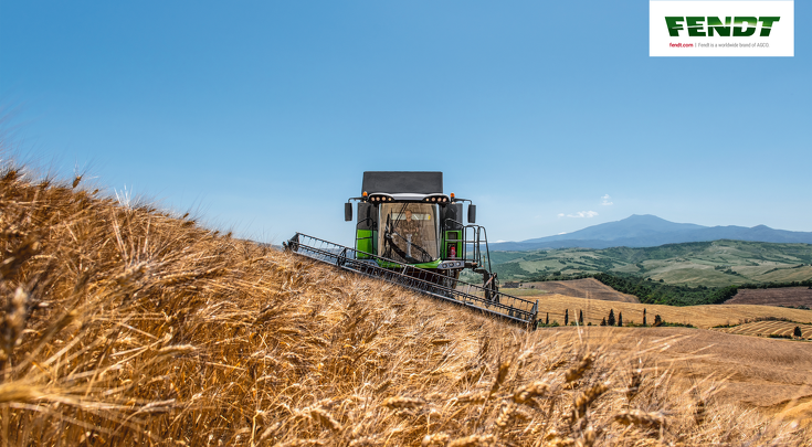 A Fendt C Series combine threshing in a grain field.