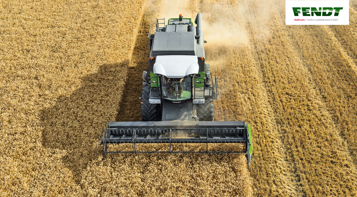 A Fendt E-Series combine threshing in a grain field.