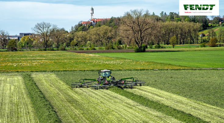 The Fendt Former 4-rotor hay rake in grassland.