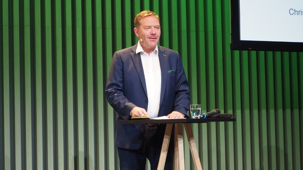 Christoph Gröblinghoff stands at a lectern on the stage