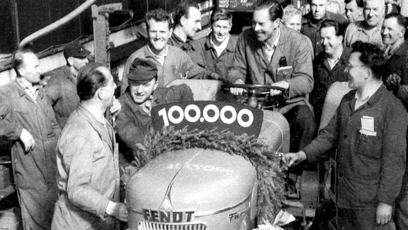 Fendt employees stand around the 100,000th tractor