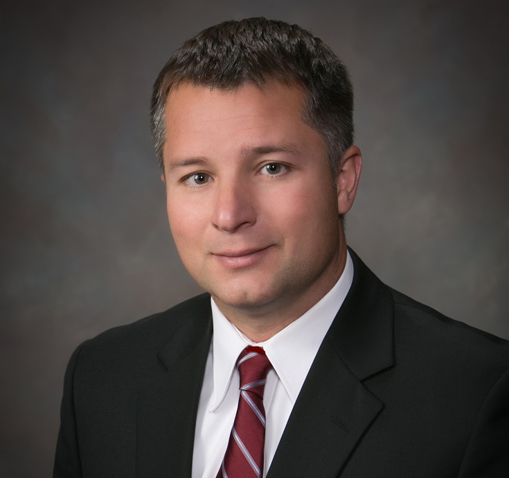 Joe DiPietro (Vice President of Fendt North America) in a suit in front of a grey backround