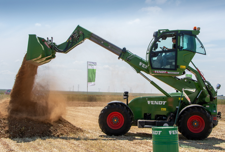 Telehandler Fendt Cargo T740 in operation with bucket and lifted lift cabin