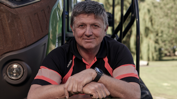 Farmer Rob Buckle standing beaming with joy in front of his Fendt machine