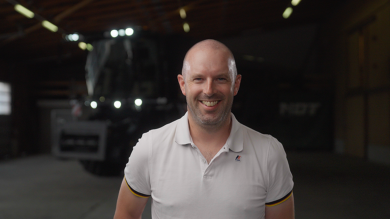 Farmer Sébastien Schmitt standing in front of a Fendt IDEAL