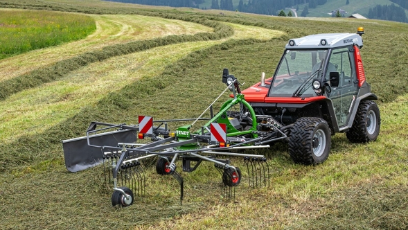 Fendt Former Alpine rake The green Fendt Former Alpine rake is in use on a mountain meadow harvesting forage. In the background you can see the rake tracks on the meadow.