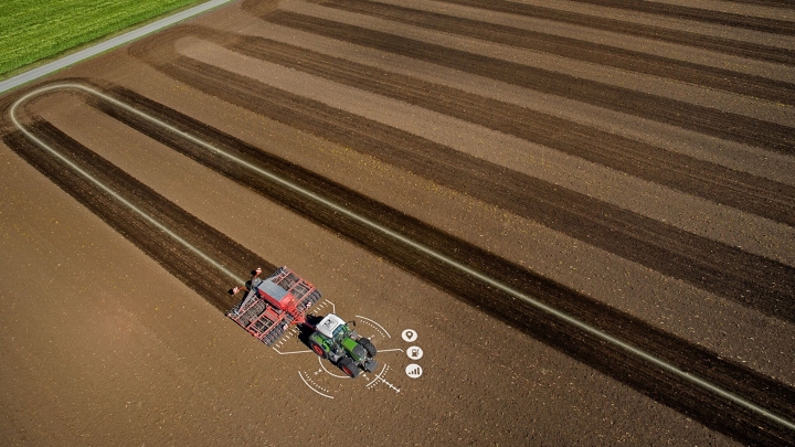 A tractor driving across a field, with the precise track visible.