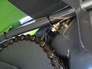 Close-up of the automatic chain lubrication system on an agricultural machine