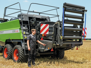 Hydraulic bale ejector and foldable bale chute on a square baler, ready for road transport.