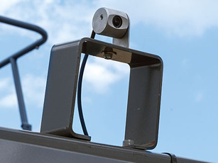 Pre-wiring and a camera port on the terminal with a rear-facing camera mounted at the end of the baling chamber.