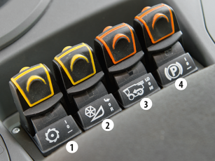 Close-up of the toggle switches in a Fendt C-Series combine harvester for controlling the threshing unit, cutterbar, all-wheel drive and parking brake.