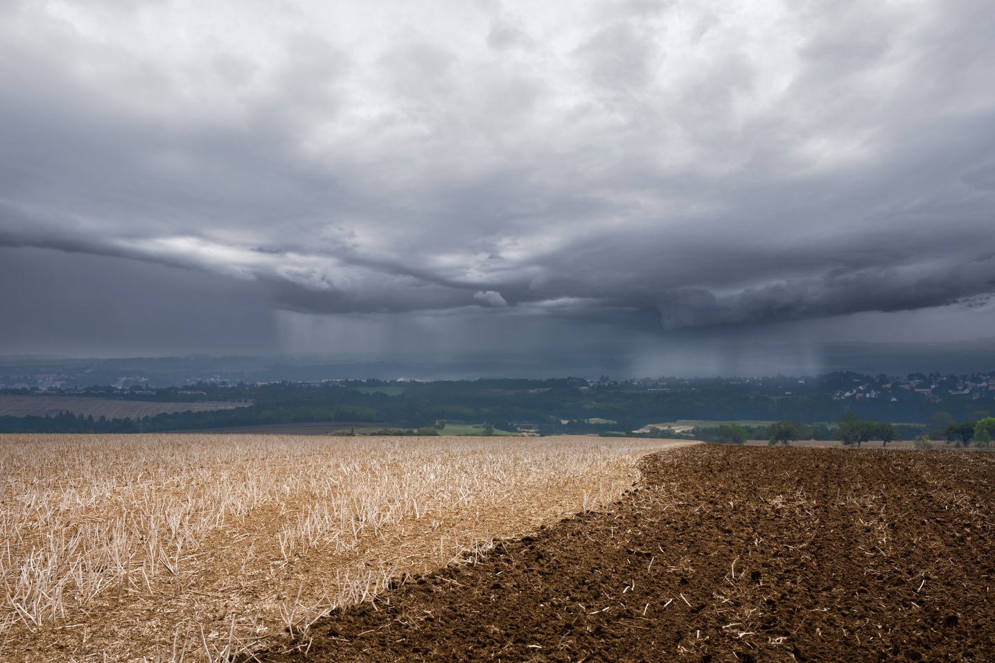 Mood picture Stubble field with storm clouds coming in A stubble field with storm clouds coming in from the distance