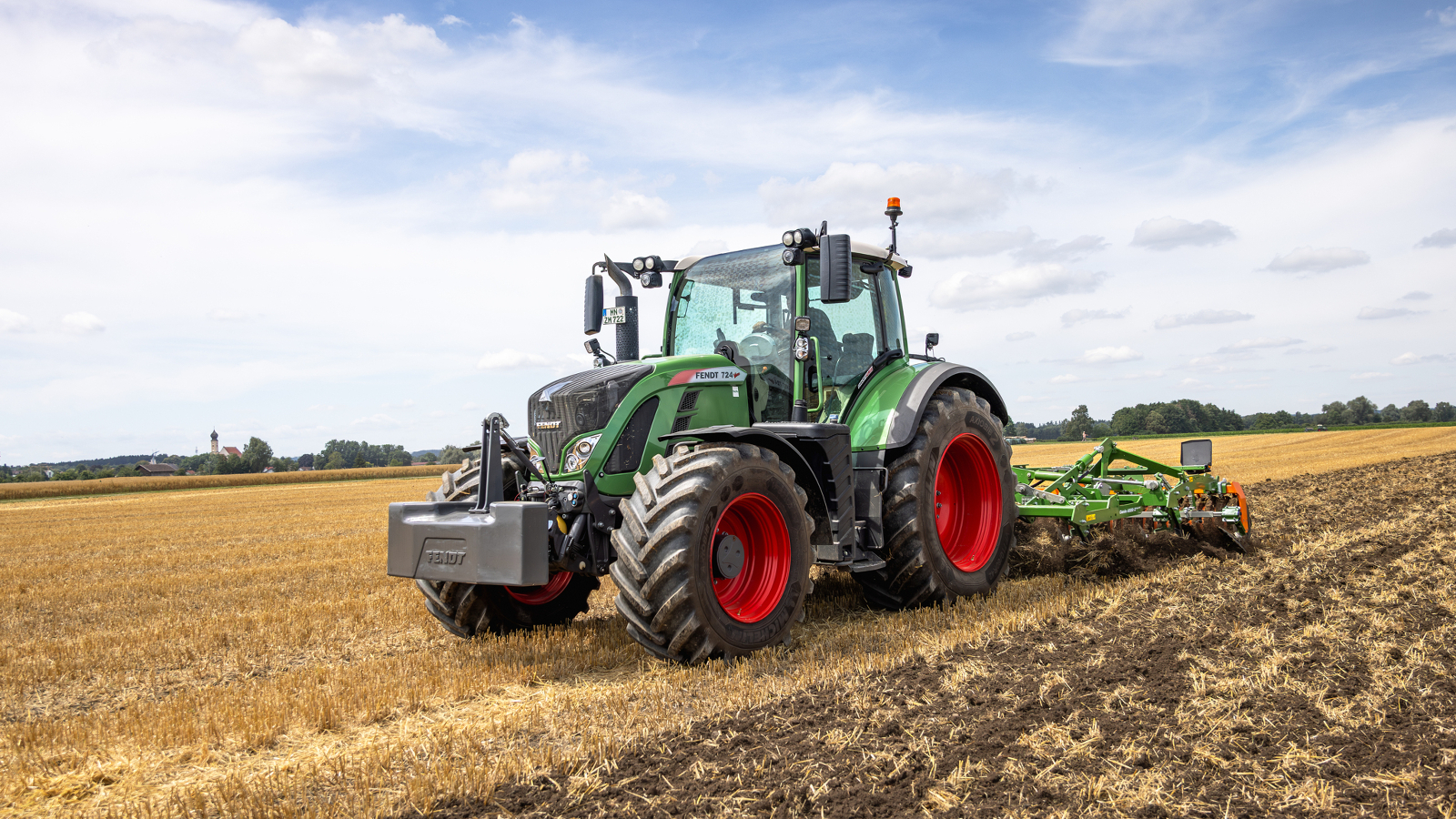 Fendt 724 Vario A farmer driving a Fendt 724 in the field.