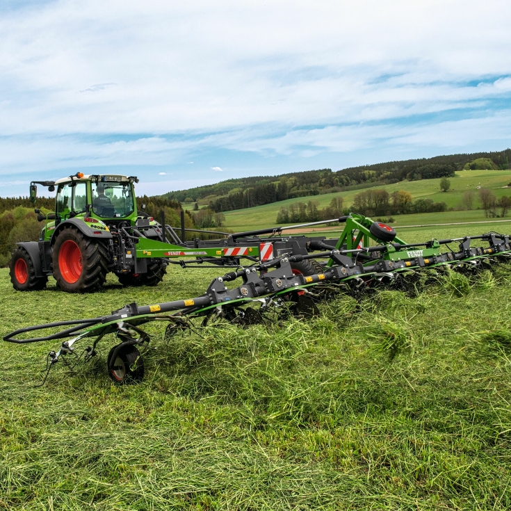 Trattore Fendt con spandi-voltafieno Fendt in azione