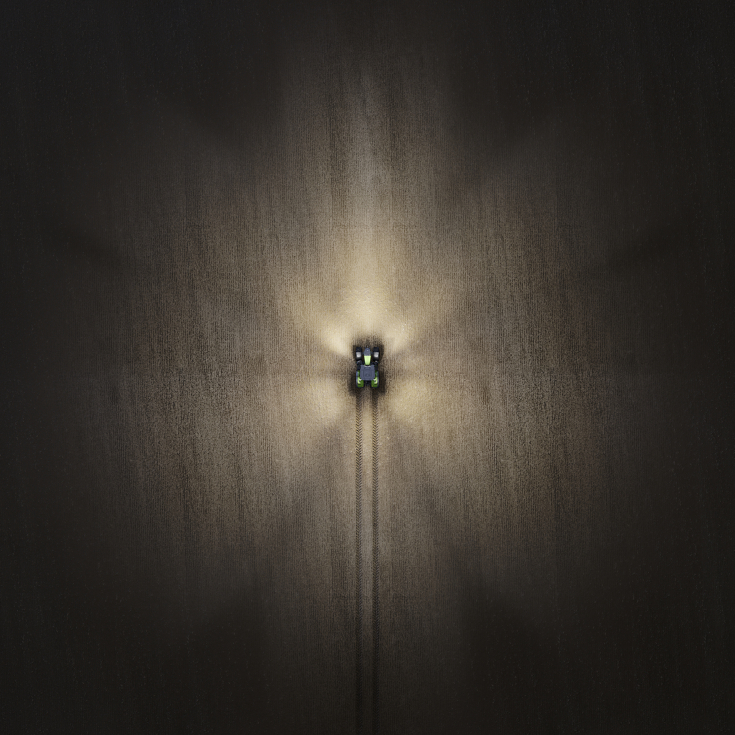 immagine scattata da un drone di un Fendt 800 Vario nella notte con luci accese.