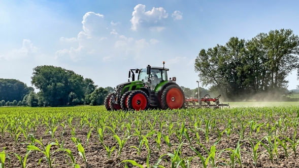 Fendt 600 Vario Zaļais Fendt 600 Vario traktors ar dubultajām riepām, kas tiek izmantots uz apstrādājamā lauka. Fonā redzami tumši zaļi koki un gaiši zilas debesis ar baltiem mākoņiem.