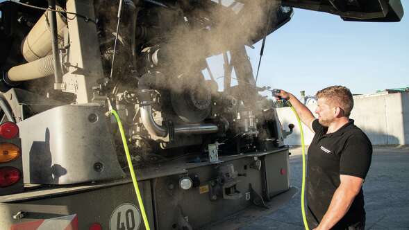 Man performing maintenance on Fendt Katana