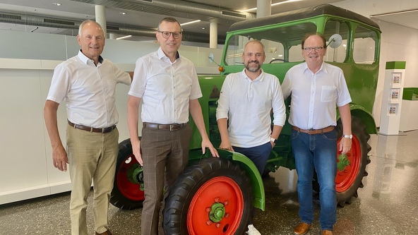 The Fendt Classic Club Board stands in front of a tractor