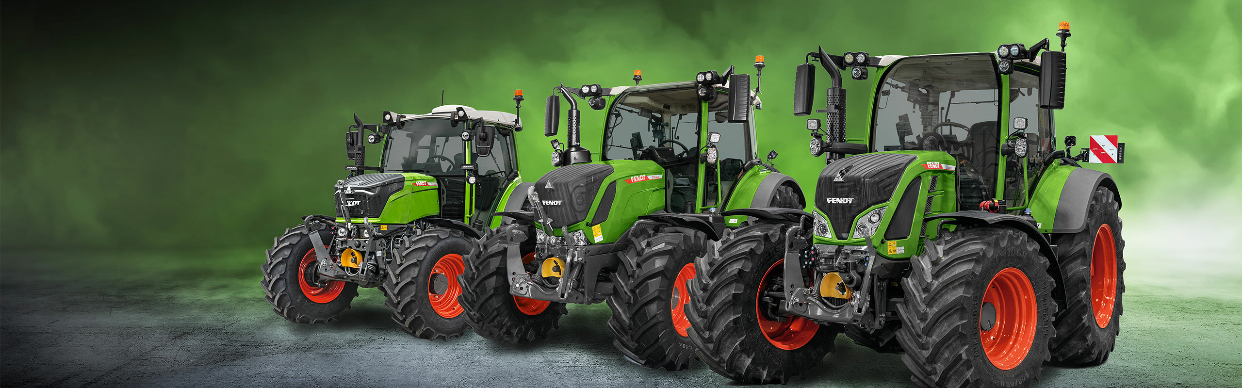 A Fendt 200, 300 and 500 Vario tractor stand side by side against a green background.