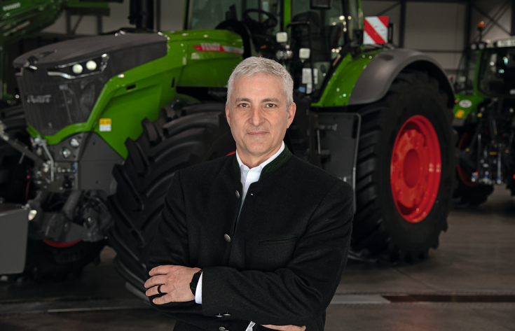 Eric Hansotia,Chairman,President and CEO AGCO in front of a Fendt tractor