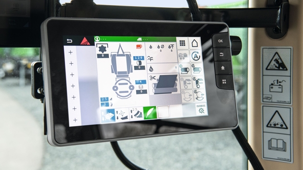 The close-up of the screen shows the open menu view for the baler.