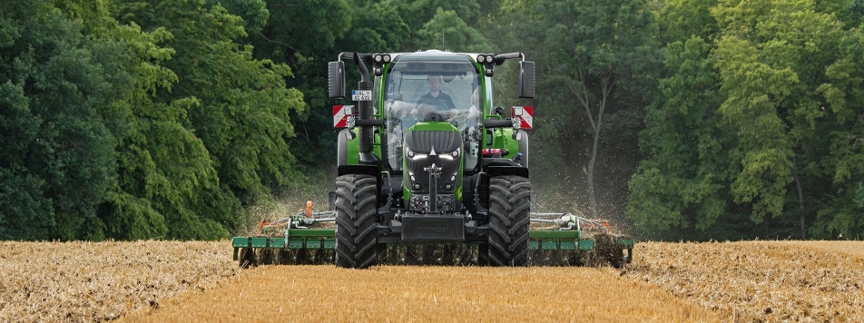 Fendt 620 Vario A Fendt 620 Vario on the field during soil cultivation with forest in the background