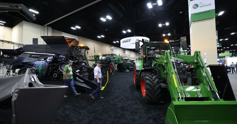 Farmers walk around the Fendt Booth  at Commodity Classic