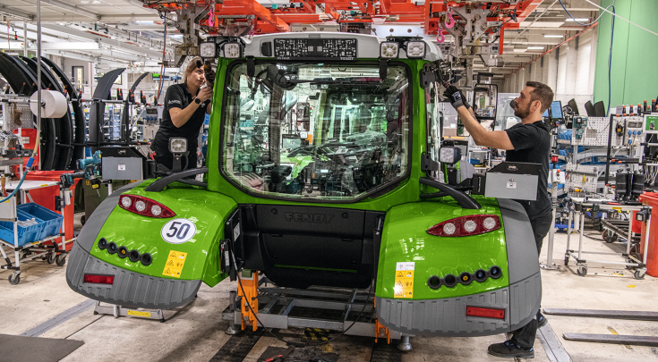 Fendt cab assembly with automatic overhead conveyor system that lowers the cab precisely onto the tractor chassis.