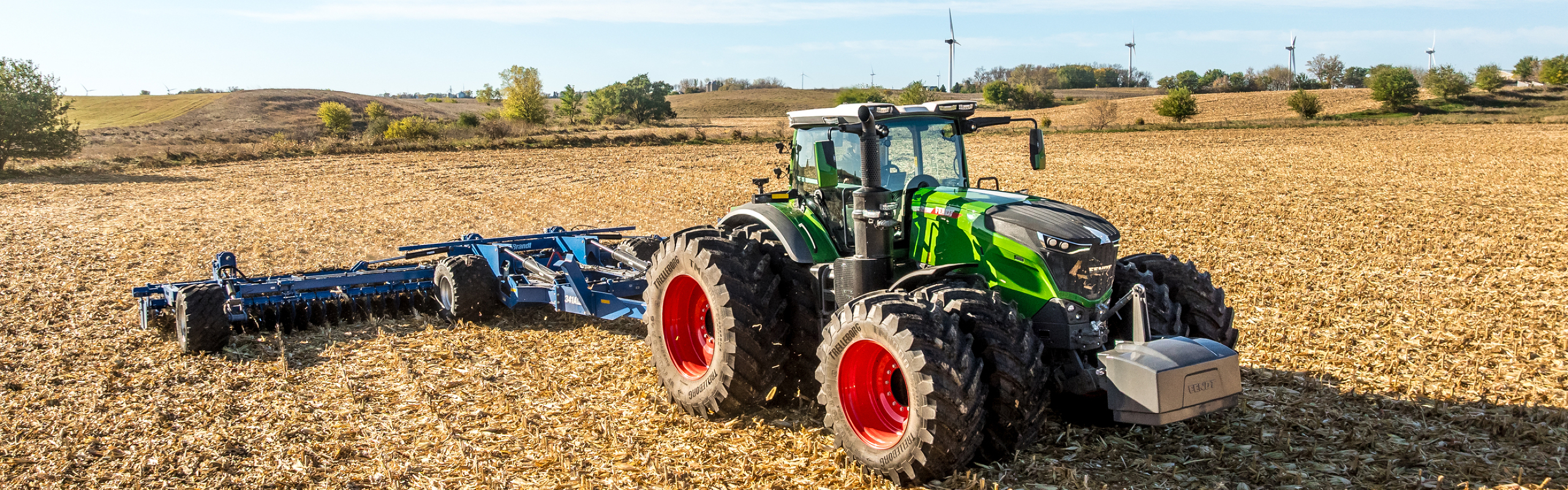 Fendt 1000 Vario Tractor pulling tillage in a field Fendt 1000 Vario Tractor pulling tillage in a field