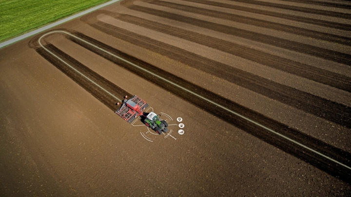 A tractor driving across a field, with the precise track visible.
