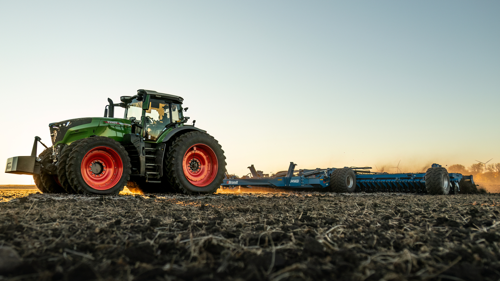 Fendt 1000 Vario Tractor pulling tillage equipment in the field Fendt 1000 Vario Tractor pulling tillage equipment in the field