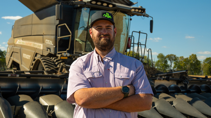 Farmer stands in front of the Fendt IDEAL Combine