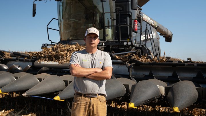 Farmer stands in front of the Fendt IDEAL Combine Farmer stands in front of the Fendt IDEAL Combine