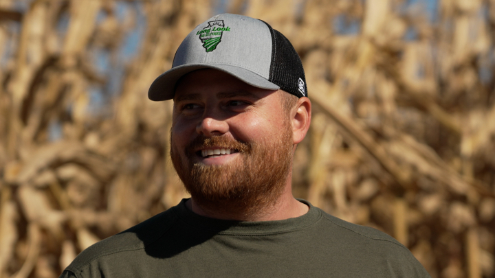 Male Farmer stands in front  of Corn Field Male Farmer stands in front  of Corn Field