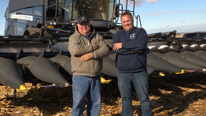 Two farmers standing in front of the Fendt IDEAL Combine Two farmers standing in front of the Fendt IDEAL Combine