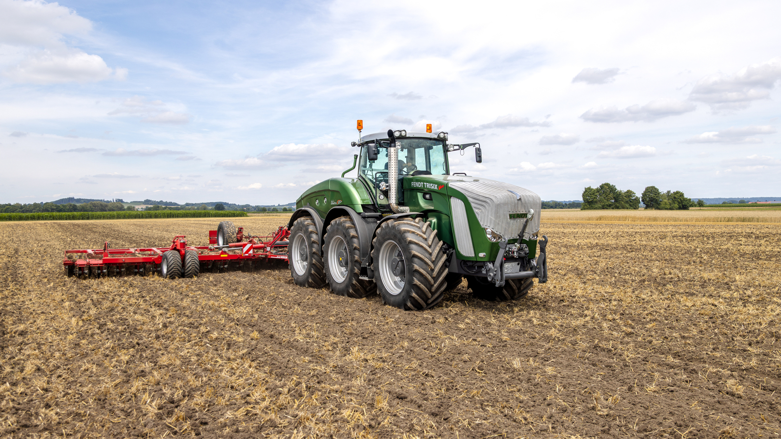 A farmer driving a Fendt Trisix in a field.